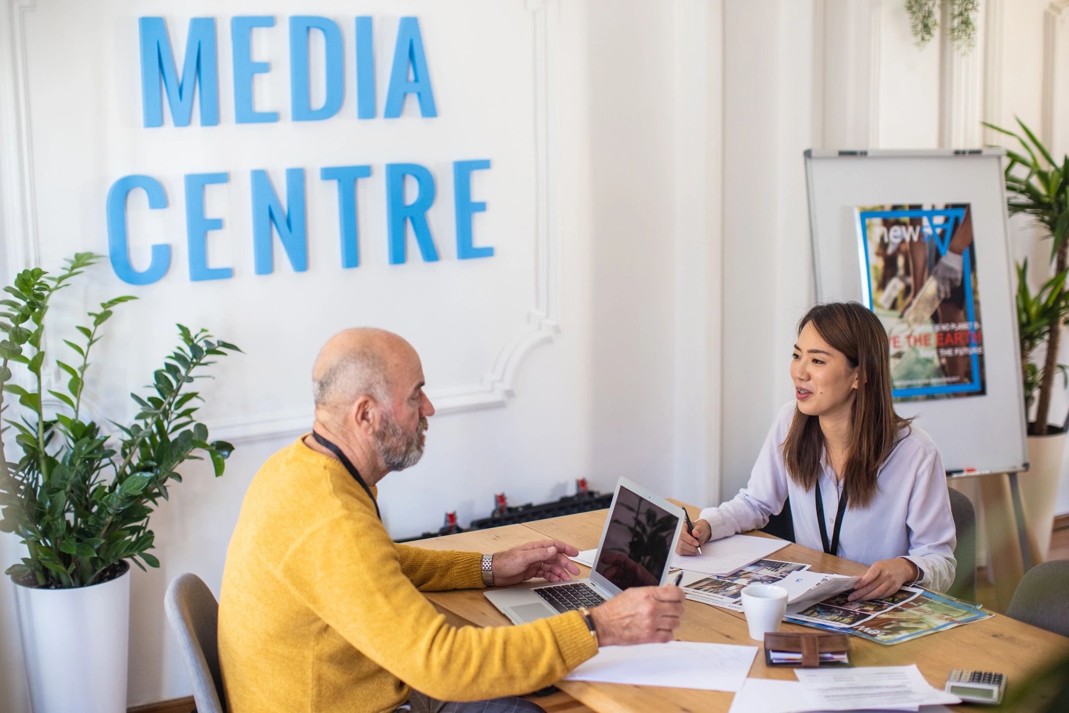 Team discussing travel plans in an office setting