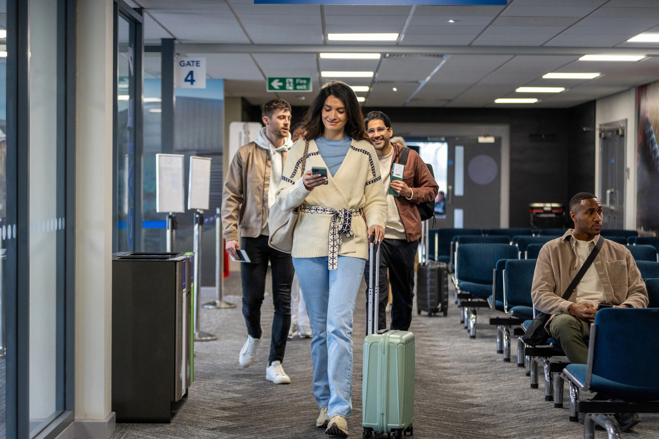Travelers walking toward an airport gate