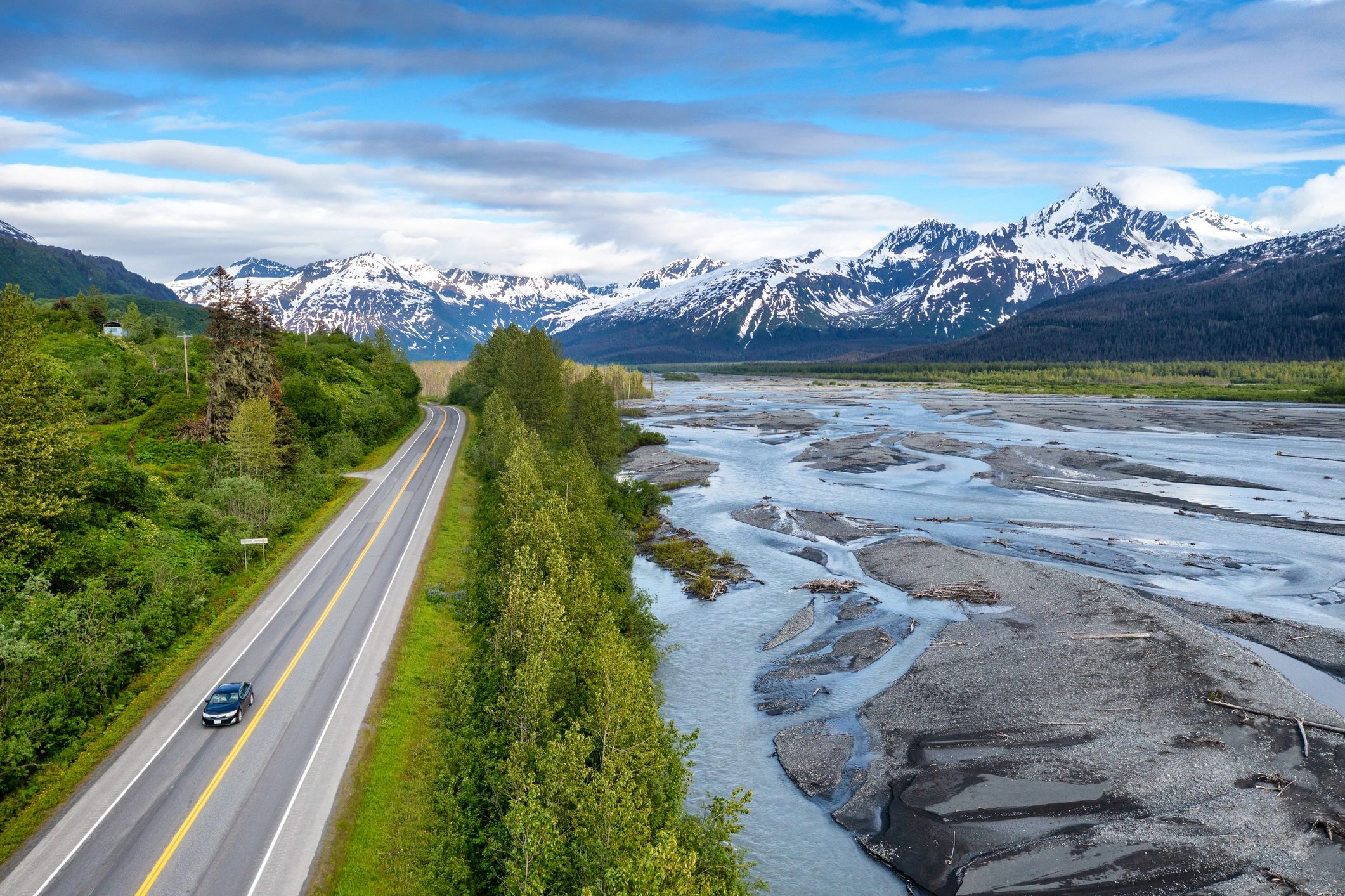 Road leading to snow-capped mountains