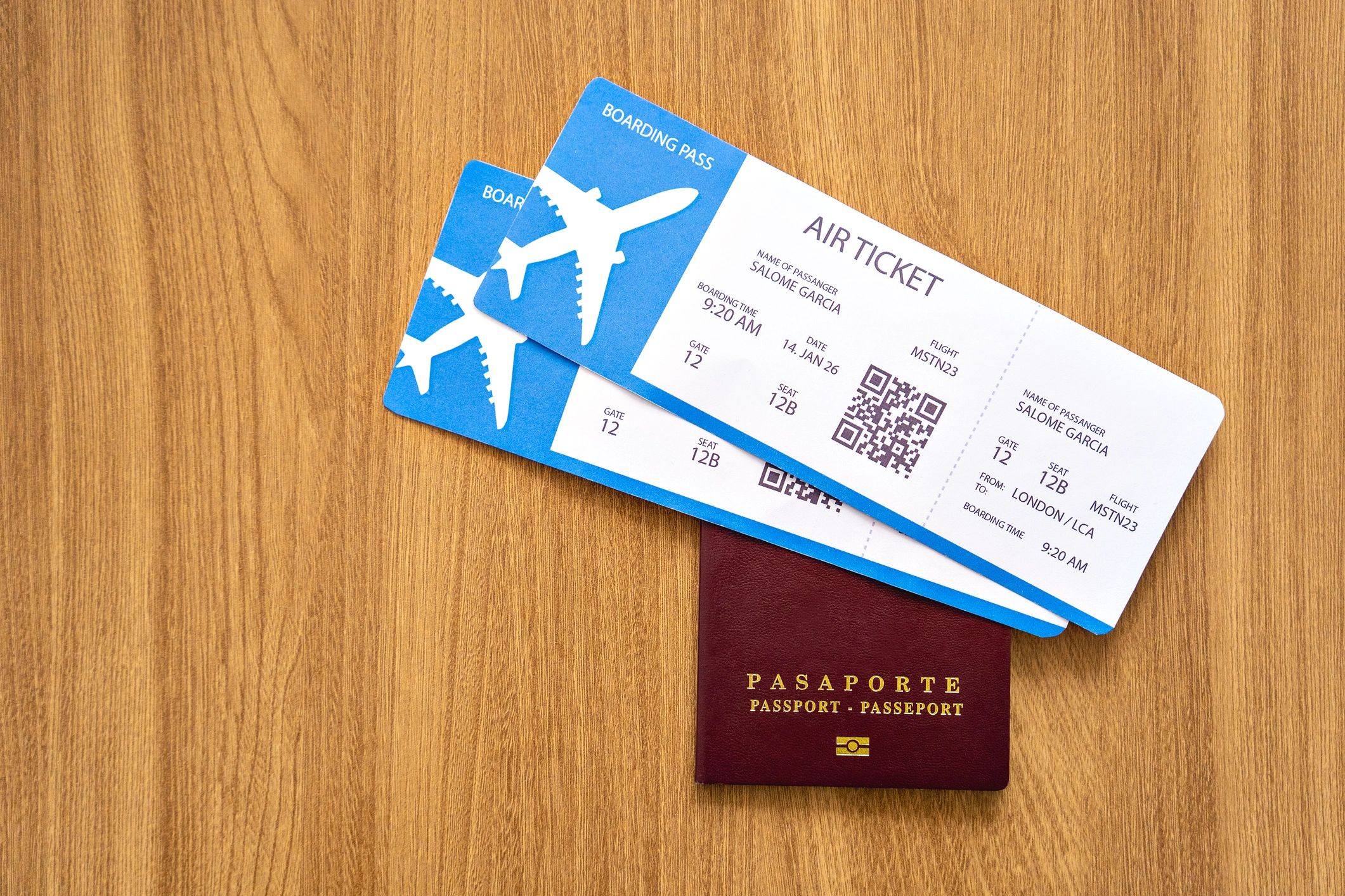 Passport and airline tickets on a wooden table