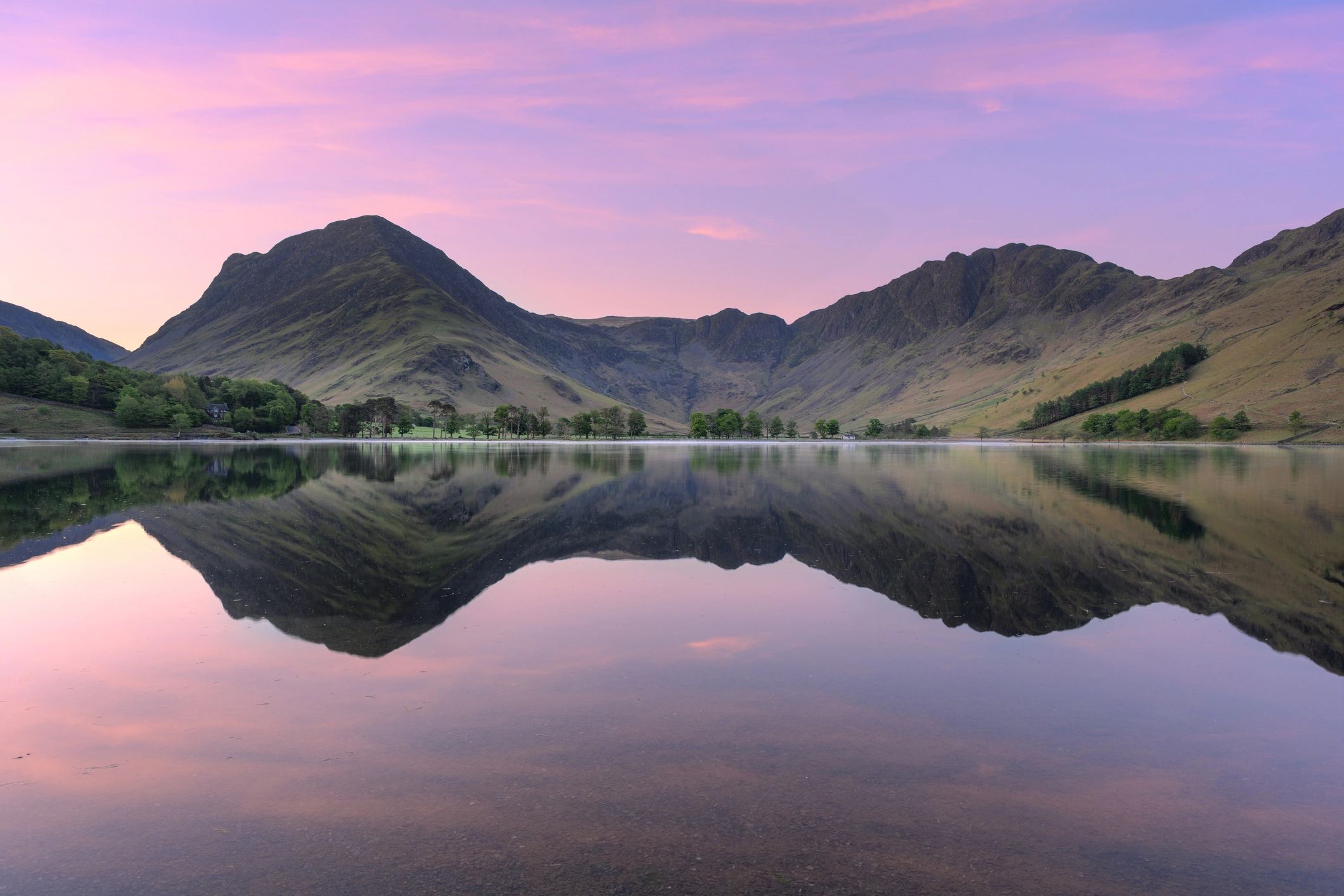 Sunrise reflections over a calm lake in the UK