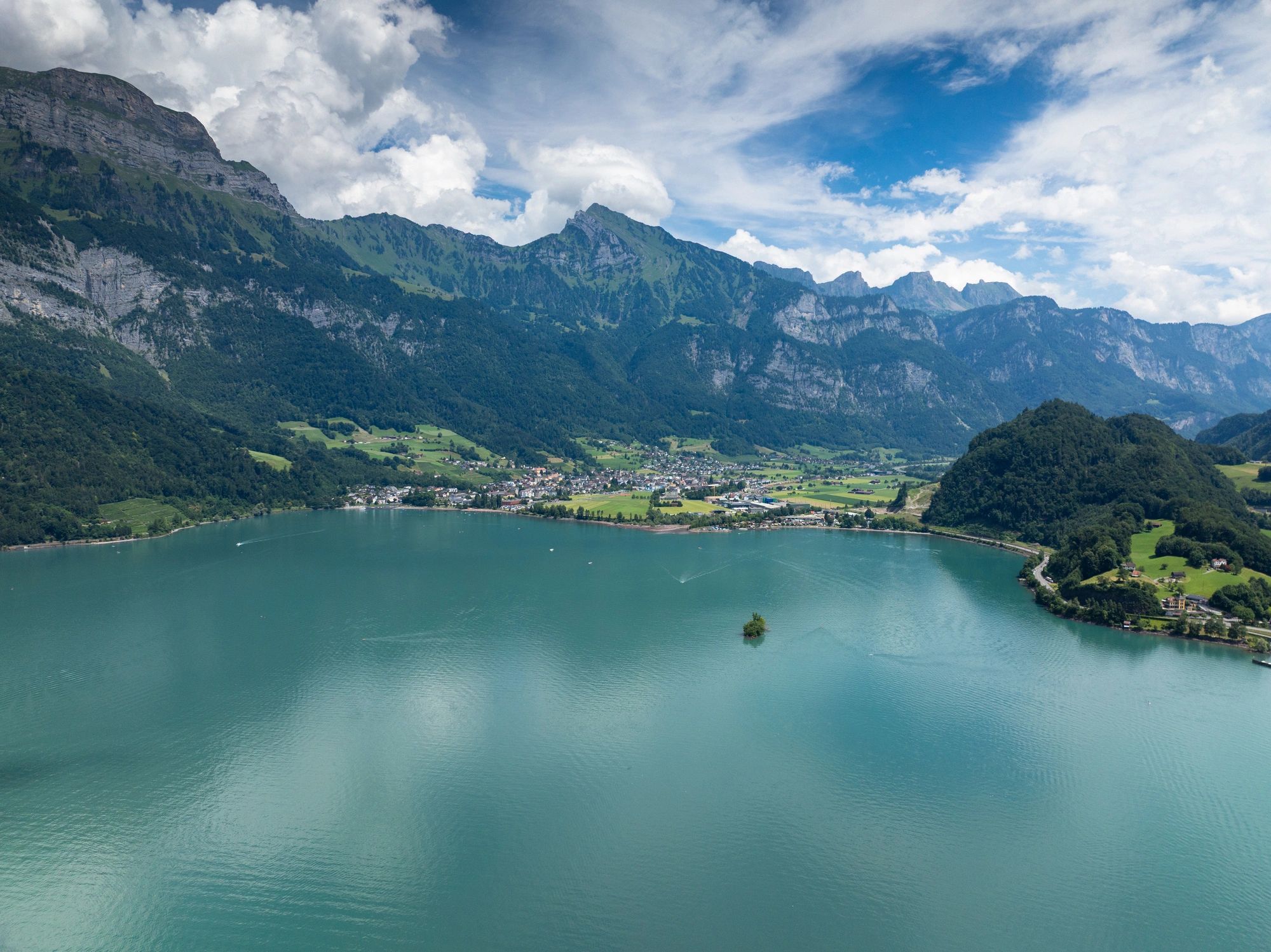 Turquoise mountain lake and village